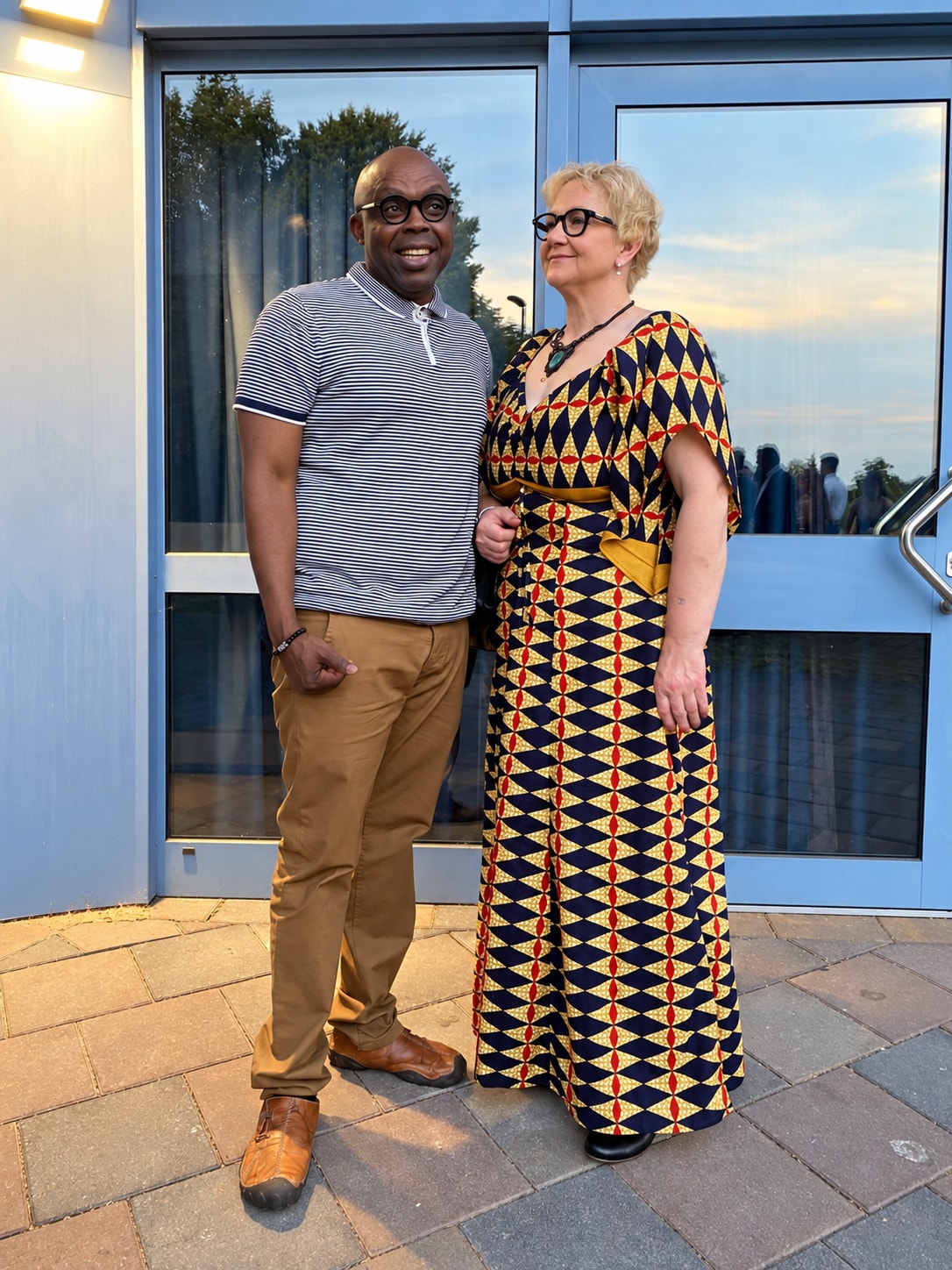 Bobby and Sylvia in front of a glass door
